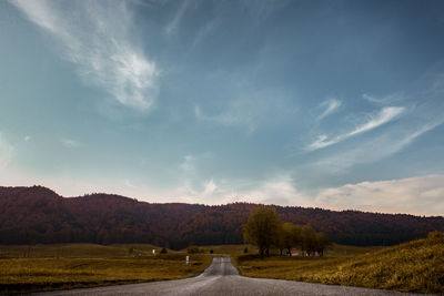 Road amidst landscape against sky