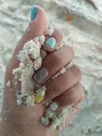 Cropped hand of woman holding flour