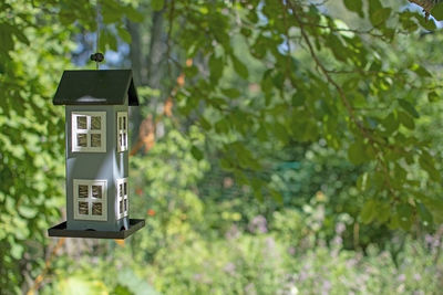 Low angle view of birdhouse hanging on tree