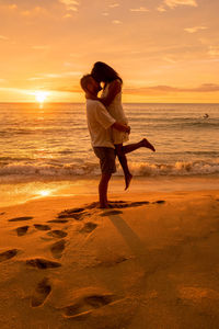 Full length of woman on beach during sunset