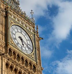 Low angle view of clock tower against sky