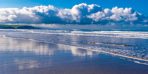 Scenic view of sea against cloudy sky