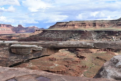 View of rock formation against cloudy sky