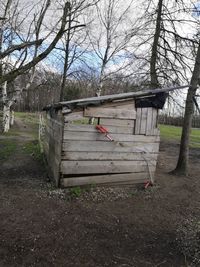 Built structure on field against trees