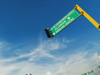 Low angle view of road sign against sky