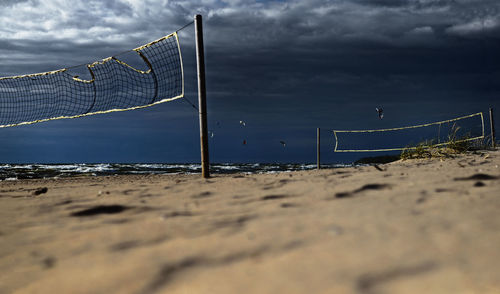 Close-up of soccer field by sea against sky