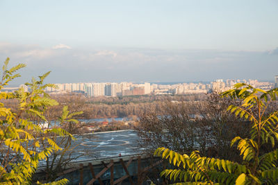 Scenic view of trees and buildings against sky