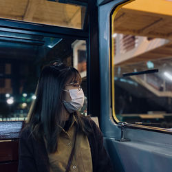 Portrait of young woman in train