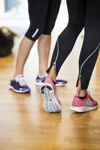 Low section of women standing at gym