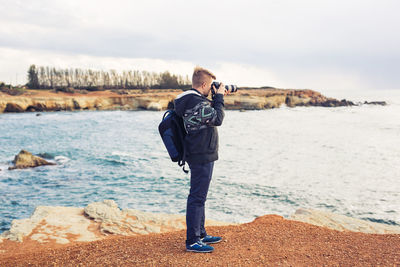 Man photographing on beach