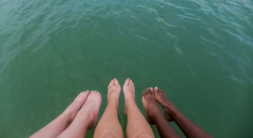 Low section of woman relaxing in water