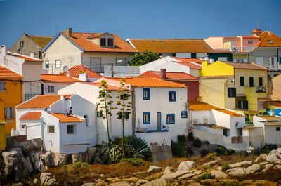 Houses in town against sky