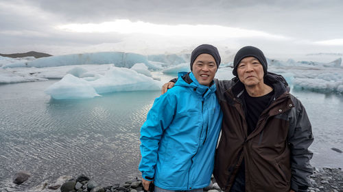 Portrait of males standing against glacier