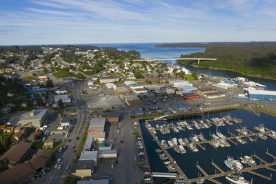 High angle view of city by sea against sky