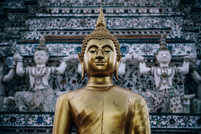 Statue of buddha against building