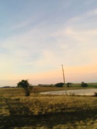 Scenic view of field against sky during sunset