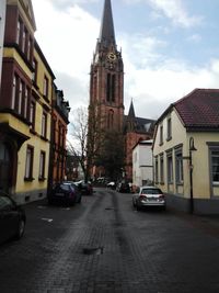 Cars on road along buildings