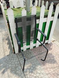 High angle view of chairs and table on sidewalk