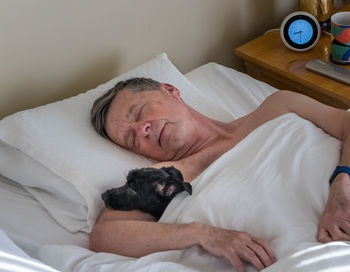 Midsection of man lying down on bed