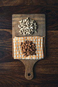 Directly above shot of cashew and almonds on wooden table