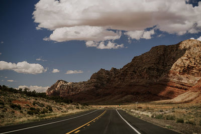 Empty road leading towards mountains