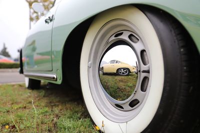 Close-up of porsche 356 mooneye rims with whitewall tires