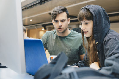 Computer programmers using laptop at office