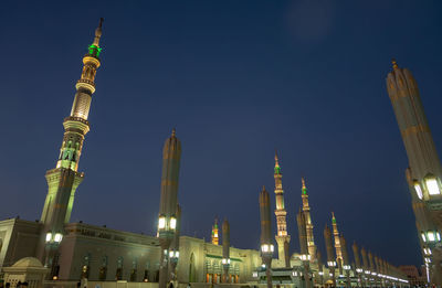 Low angle view of illuminated buildings against sky at night nabawi mosque medina