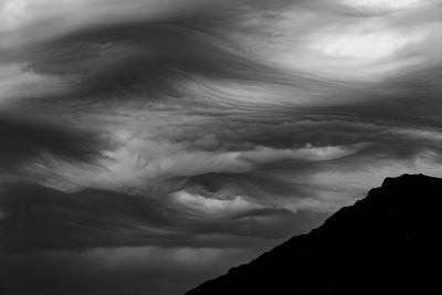 Low angle view of storm clouds over mountain