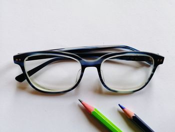 Close-up of eyeglasses on table against white background