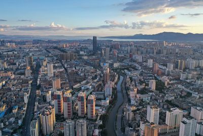 Aerial view of city against sky during sunset