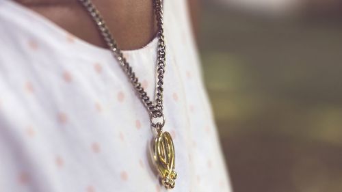 Mid section of woman wearing necklace