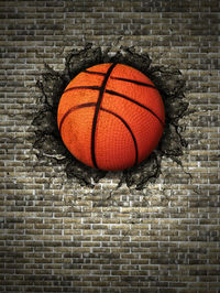 Close-up of basketball amidst wall