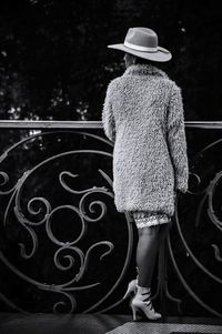 Woman standing on bridge in city during winter