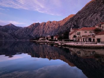 Reflection of buildings in lake against sky