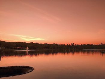 Scenic view of lake against romantic sky at sunset