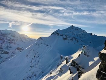 Scenic view of snow covered mountains against sky