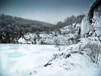 Scenic view of mountains against clear sky during winter