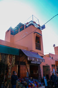 People at market against buildings in city