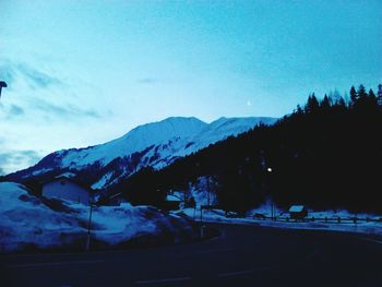 Scenic view of mountains against blue sky