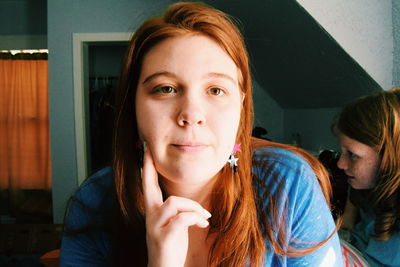 Close-up portrait of young woman at home