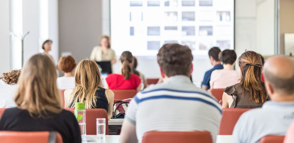 Rear view of people in meeting