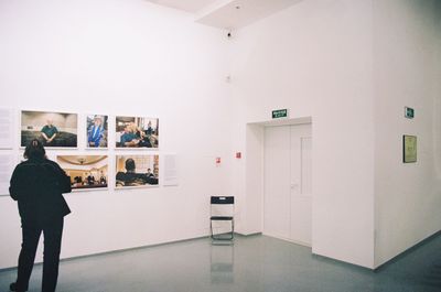 Rear view of man standing in front of museum