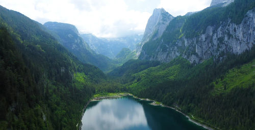 Scenic view of river amidst mountains against sky