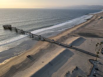 Aerial view of venice pier, venice beach and santa monica bay at sunset.