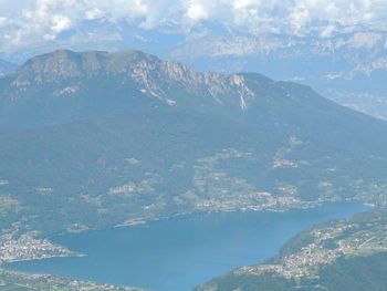 Aerial view of sea and mountains against sky