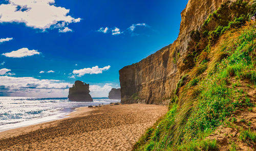 Scenic view of beach against blue sky