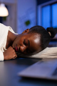 Portrait of man sleeping on table