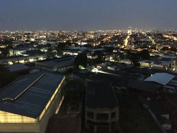 High angle view of buildings in city at night