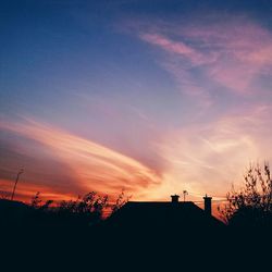 Low angle view of silhouette trees against sky at sunset